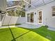 Outdoor patio features artificial grass and caged roof, connecting indoor living spaces at 5636 Whitehead St, Bradenton, FL 34203