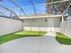 Outdoor patio features artificial grass, a white privacy wall, and a caged roof at 5636 Whitehead St, Bradenton, FL 34203