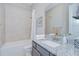 Well-lit bathroom featuring granite counters, vanity, and a shower and tub combo at 5728 Watercolor Dr, Lithia, FL 33547