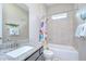 Bathroom featuring vanity with granite countertop, bathtub and shower with colorful curtain at 5728 Watercolor Dr, Lithia, FL 33547