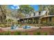 Community area with Adirondack chairs surrounding a fire pit and a cozy clubhouse in the background at 5728 Watercolor Dr, Lithia, FL 33547