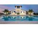 Community pool in a clubhouse setting with a tower, lounge chairs, and well manicured landscaping at 5728 Watercolor Dr, Lithia, FL 33547