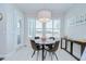 Cozy dining area with natural light, featuring modern light fixture, and comfortable seating at 5728 Watercolor Dr, Lithia, FL 33547
