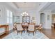 Bright dining room with tray ceiling, hardwood floors, and a decorative china cabinet at 5728 Watercolor Dr, Lithia, FL 33547