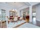 Open dining room with hardwood floors, tray ceiling, and seamless flow into living area at 5728 Watercolor Dr, Lithia, FL 33547