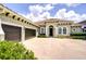 Beautiful single-story home featuring a large driveway, three-car garage and tile roof at 5728 Watercolor Dr, Lithia, FL 33547