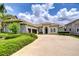 Attractive home with a tile roof, three-car garage and well-maintained landscaping at 5728 Watercolor Dr, Lithia, FL 33547