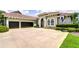 Beautiful home with a three-car garage, tile roof, and a spacious driveway at 5728 Watercolor Dr, Lithia, FL 33547