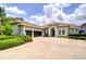 Stunning single-story home boasting a three-car garage and tile roof, set against a blue sky at 5728 Watercolor Dr, Lithia, FL 33547