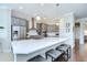 Modern kitchen featuring a large island with seating and stainless-steel appliances at 5728 Watercolor Dr, Lithia, FL 33547