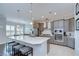 Modern kitchen with gray cabinets, stainless appliances, a large island with seating, and pendant lighting at 5728 Watercolor Dr, Lithia, FL 33547