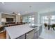 Spacious kitchen island with stainless sink and dishwasher offers seating and overlooks the living and dining areas at 5728 Watercolor Dr, Lithia, FL 33547