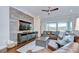 Comfortable living room with wood accent wall, ceiling fan, and leather furniture at 5728 Watercolor Dr, Lithia, FL 33547