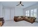 Bright living room with a comfortable sectional couch and two white doors at 5728 Watercolor Dr, Lithia, FL 33547