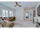 Spacious living room features a comfortable sectional couch and lots of natural light from the windows at 5728 Watercolor Dr, Lithia, FL 33547