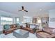 Inviting living room with leather sofas, open layout, ceiling fan, and views into the kitchen and lanai at 5728 Watercolor Dr, Lithia, FL 33547