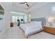 Serene main bedroom with tray ceiling, neutral tones, and a separate sitting area filled with natural light at 5728 Watercolor Dr, Lithia, FL 33547
