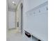Hallway with white mudroom storage featuring bench, hooks, and tiled flooring at 5728 Watercolor Dr, Lithia, FL 33547