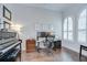 Well-lit office featuring hardwood floors, a piano, and a large workstation with monitors at 5728 Watercolor Dr, Lithia, FL 33547