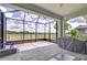 View of open screened patio with brick floors, grill, furniture, and expansive backyard at 5728 Watercolor Dr, Lithia, FL 33547