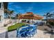 Beautiful backyard with a large table with chairs and sunshade at 650 70Th Ave, St Pete Beach, FL 33706