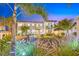 Relax in this backyard oasis with a fire pit, plush lawn, comfortable seating, and tropical palms at 650 70Th Ave, St Pete Beach, FL 33706