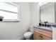 Modern bathroom with a sleek vanity, contemporary fixtures, and a window providing natural light and a view at 650 70Th Ave, St Pete Beach, FL 33706