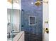 Luxurious bathroom shower featuring blue tile walls, gold fixtures, and a convenient built-in niche at 650 70Th Ave, St Pete Beach, FL 33706