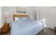 Bright bedroom featuring a large bed with a decorative headboard and calming blue bedding at 650 70Th Ave, St Pete Beach, FL 33706