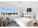 Bright bedroom featuring a view, stylish chair, and sleek, modern finishes at 650 70Th Ave, St Pete Beach, FL 33706