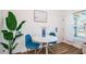 Cozy dining area featuring a round white table with stylish blue chairs and a large window offering natural light at 650 70Th Ave, St Pete Beach, FL 33706