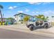 Modern two-story home with white fence, attractive landscaping, golf cart, and customized Jeep Gladiator at 650 70Th Ave, St Pete Beach, FL 33706
