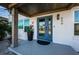 Inviting front entrance with blue door, modern lighting, and manicured plants at 650 70Th Ave, St Pete Beach, FL 33706