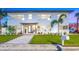 Beautiful two-story home with well-manicured lawn, tropical plants and tiled entryway at 650 70Th Ave, St Pete Beach, FL 33706