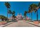 A grand hotel entrance lined with palm trees against a clear blue sky invites guests to a luxurious experience at 650 70Th Ave, St Pete Beach, FL 33706