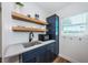 Modern kitchen featuring stainless sink, gray countertops, and blue shaker cabinets at 650 70Th Ave, St Pete Beach, FL 33706