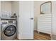 Convenient laundry room with modern washer/dryer, storage, and an adjacent doorway at 650 70Th Ave, St Pete Beach, FL 33706