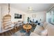 Bright living room featuring a comfortable sofa, stylish decor, a hanging chair, and large windows with scenic views at 650 70Th Ave, St Pete Beach, FL 33706