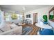 Comfortable living room boasts modern decor, bright natural light, and a relaxing swing chair at 650 70Th Ave, St Pete Beach, FL 33706