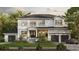 Stunning two-story white home with a charming front porch, lush landscaping, and an attached two-car garage at 690 Geneva Pl, Tampa, FL 33606