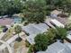 Aerial view of home with mature trees, pool, driveway and fenced backyard at 7004 Lambright Ct, Tampa, FL 33634