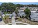 Aerial shot of a home on a large lot with mature landscaping and a long driveway at 7004 Lambright Ct, Tampa, FL 33634