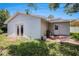 Backyard featuring brick patio and the exterior of the home at 7004 Lambright Ct, Tampa, FL 33634