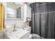 Bathroom with a sink, toilet, vanity with storage and a shower at 7004 Lambright Ct, Tampa, FL 33634