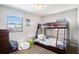 Cozy bedroom with a wood bunk bed, natural light from the window at 7004 Lambright Ct, Tampa, FL 33634