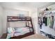 Bedroom featuring a wooden bunk bed with a closet and carpet flooring at 7004 Lambright Ct, Tampa, FL 33634