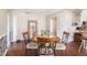 Comfortable dining area featuring a round wooden table, four chairs, and hardwood flooring at 7004 Lambright Ct, Tampa, FL 33634
