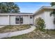 Charming home with a well-kept lawn, walkway, and inviting entrance, perfect for a Gathering at 7004 Lambright Ct, Tampa, FL 33634