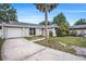 Inviting single-Gathering home with a spacious driveway, lush lawn, and a welcoming entrance at 7004 Lambright Ct, Tampa, FL 33634