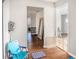 Hallway with hardwood floors, neutral paint, and a view into other rooms, creating a spacious feel at 7004 Lambright Ct, Tampa, FL 33634